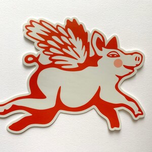 May include: A red and white sticker of a pig with wings. The pig is flying and has a happy expression on its face.