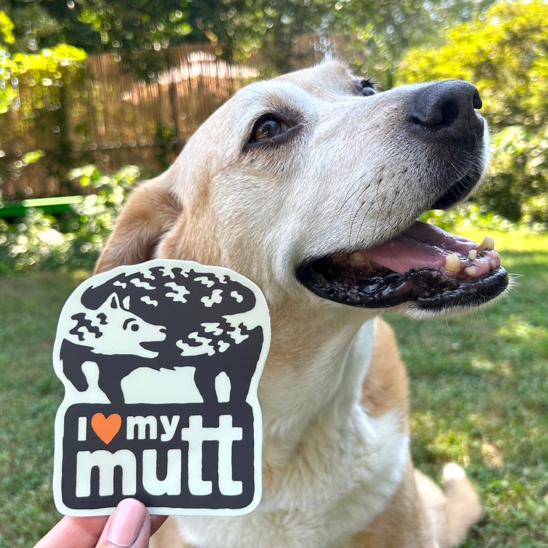 May include: A white sticker with a black and white illustration of a dog with a heart and the text "I love my mutt".