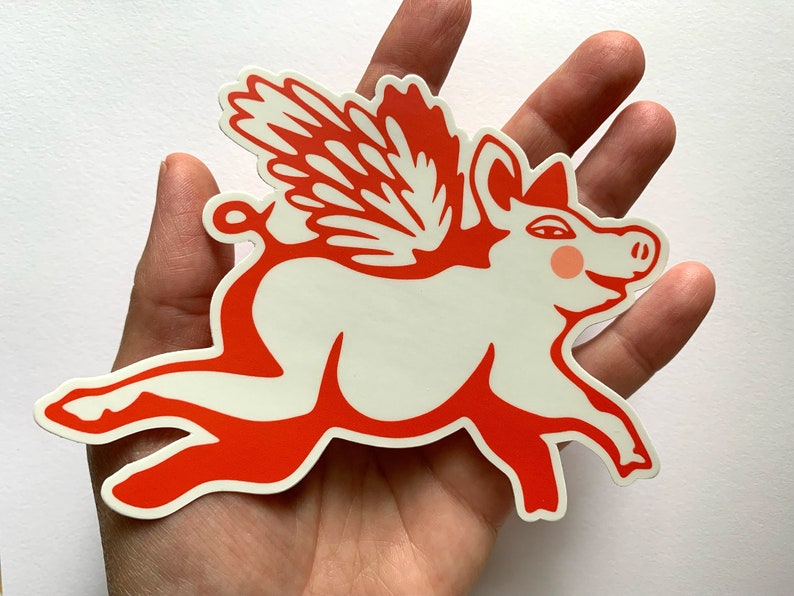 May include: A red and white sticker of a pig with wings. The pig is flying and has a happy expression on its face.