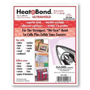 May include: A white package of Heat'n Bond Ultrahold iron-on adhesive, measuring 43 cm by 0.9 m. The package features a red and white design with the text "For The Strongest, "No-Sew" Bond" and "La Colle Plus Solide Sans Couture".