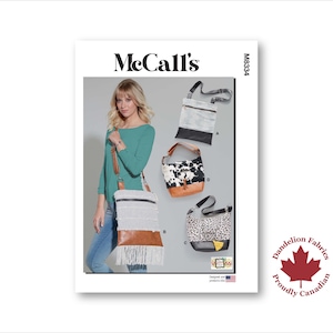 May include: McCall's sewing pattern M8334 featuring various bag designs. The image shows a woman wearing a teal top and jeans, carrying a white and brown fringed bag. Other bag styles include a cowhide print and a leopard print.