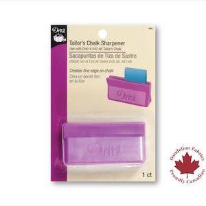 May include: Purple plastic tailor's chalk sharpener with the Dritz brand name.  The packaging includes the text "Tailor's Chalk Sharpener", "Use with Dritz #642-66 Tailor's Chalk", "Sacapuntas de Tiza de Sastre", "Utilizar con la Tiza de Sastre Dritz No. 642-66", "Creates fine edge on chalk", "Crea un borde fino en la tiza", and "1 ct".