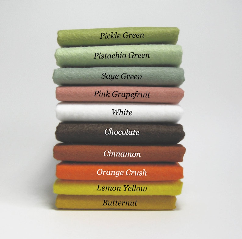 May include: A stack of ten felt squares in various colors, including pickle green, pistachio green, sage green, pink grapefruit, white, chocolate, cinnamon, orange crush, lemon yellow, and butternut.