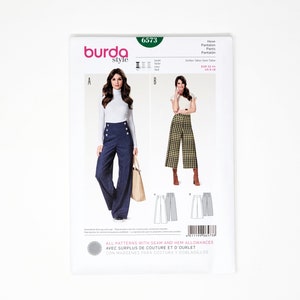May include: Burda Style sewing pattern number 6573 for wide-leg pants. The pattern includes two styles: one with a high waist and button detailing, and the other with a cropped, plaid design. The pattern includes seam and hem allowances.