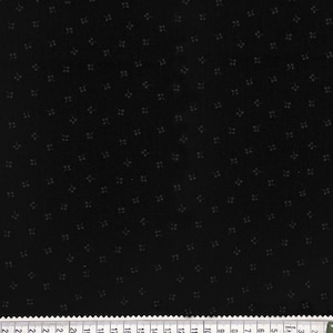 Puede incluir: Tela negra con un patrón repetitivo de pequeñas flores blancas.