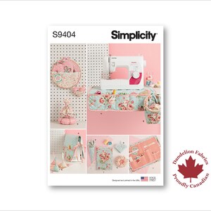 May include: A Simplicity sewing pattern package, S9404, showcasing a sewing machine and sewing accessories. The image has a pink and floral theme, with a sewing machine, storage pockets, and a pin cushion. The Dandelion Fabrics logo is also visible.