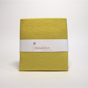 May include: A sheet of yellow felt fabric with a white label that reads "Dandelion Fine Fabrics and Notions".