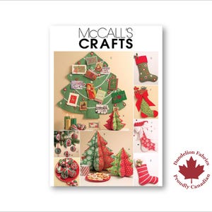 May include: A magazine cover with the text "McCall's Crafts" showcases various Christmas craft projects. The projects include a felt Christmas tree, stockings, ornaments, and decorative trees. The image also includes the "Dandelion Fabrics" logo.