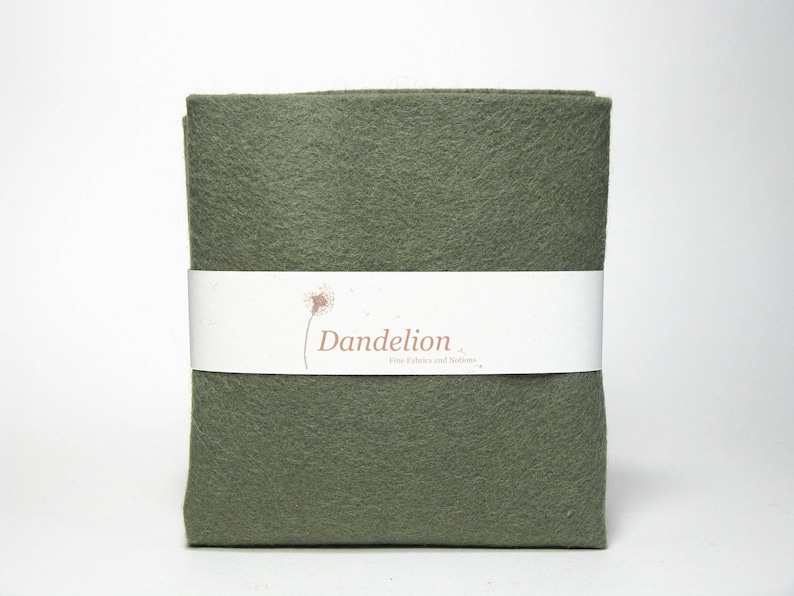 May include: A green felt sheet with the text "Dandelion Felt Fabrics and Buttons" printed on a white label.