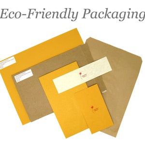May include: Eco-friendly packaging made from recycled paper. The packaging includes a brown envelope, a yellow envelope, and a smaller yellow card with a red flower logo. The text "Sustainable Paper" is printed on the card.