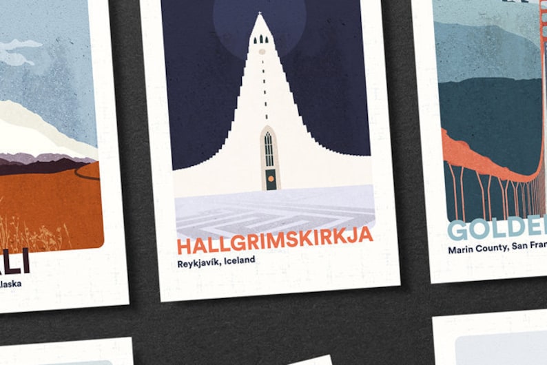 May include: A set of four illustrated postcards featuring iconic landmarks. The postcards are printed on white cardstock with a textured surface. The first postcard features a mountain range with snow-capped peaks. The second postcard features a tall, white church with a steeple. The third postcard features a bridge with red supports. The fourth postcard features a bridge with orange supports. The text on the postcards reads "Denali, Alaska", "Hallgrimskirkja, Reykjavik, Iceland", "Golden Gate Bridge, Marin County, San Francisco", and "Golden Gate Bridge, Marin County, San Francisco".