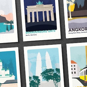 May include: Six illustrated postcards featuring famous landmarks around the world. The postcards are white with a light blue, gray, and yellow color scheme. The landmarks include Banff, Brandenburg Gate, Angkor Wat, Helsinki Cathedral, Petronas Towers, and Lisbon.