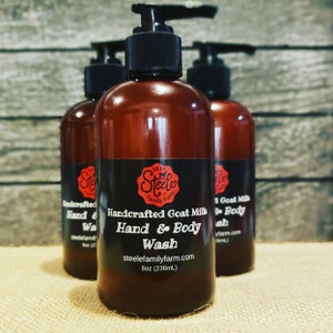 May include: Three amber glass bottles of goat milk hand and body wash. The center bottle label reads "Handcrafted Goat Milk Hand & Body Wash" with the website "steelefamilyfarm.com" and "8oz (236mL)".