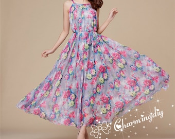 May include: A sleeveless maxi dress with a floral print in shades of pink, blue, and green. The dress has a halter neckline and a tie at the waist.