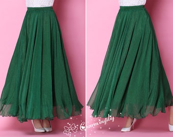 May include: A long, flowing green skirt with a ruffled hem. The skirt is made of a sheer fabric and has a simple, elegant design.