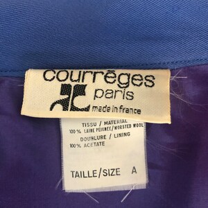 May include: A white tag with black text that reads "courr&egrave;ges paris made in france" and details the fabric composition: "TISSU / MATERIAL 100% LAINE PEIGNEE/WORSTED WOOL DOUBLURE / LINING 100% ACETATE TAILLE/SIZE A".