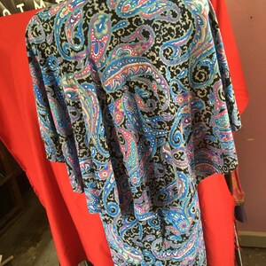 May include: A black and blue paisley patterned dress with a long skirt and short sleeves.