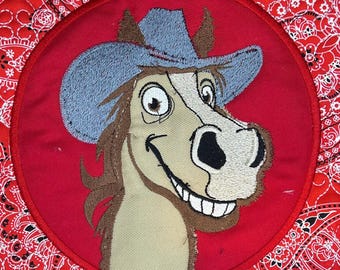 May include: A smiling cartoon horse wearing a blue cowboy hat with a red background. The horse has a brown mane and tail and a white face.