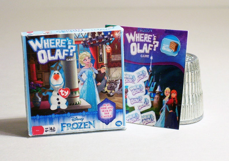 May include: A blue and white board game box with the text "Where's Olaf?" and a picture of Olaf the snowman from the Disney movie Frozen. The game is for ages 4 and up.