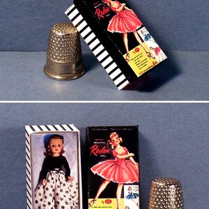 May include: Two boxes of Revlon dolls, one with a doll wearing a black and white polka dot dress and the other with a doll wearing a pink dress. Both boxes have black and white stripes and the text "Beautiful Revlon Doll" on the front.