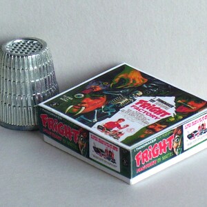 May include: A vintage board game box with a green, white, and red design. The box features a monster with a bone in its hand and the text "The Thrilling FRIGHT FACTORY".