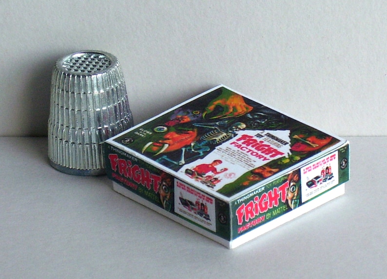May include: A vintage board game box with a green, white, and red design. The box features a monster with a bone in its hand and the text "The Thrilling FRIGHT FACTORY".