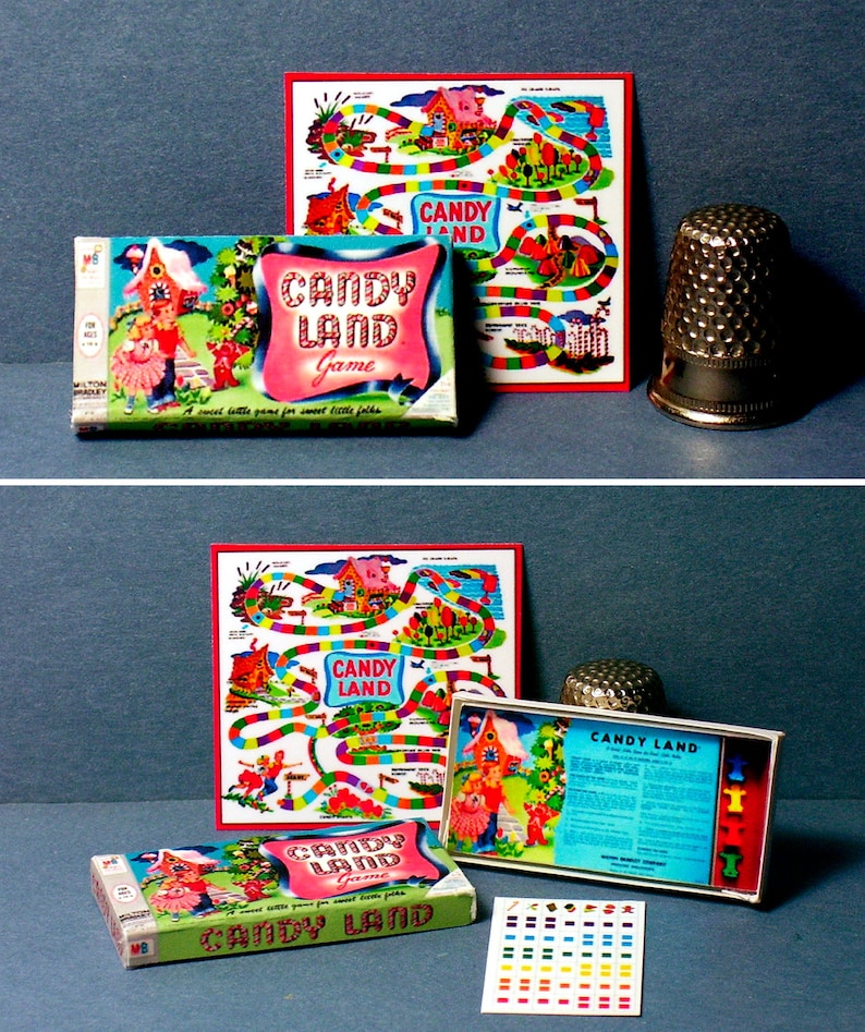 Pu&ograve; includere: Gioco da tavolo vintage Candy Land con un tabellone di gioco colorato, pedine e una scatola con un design rosa e verde. La scatola ha il testo "Candy Land Game" e "A sweet little game for sweet little folks".