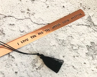 May include: A copper bookmark with a black tassel. The bookmark has the text "I love you all the words ever written" engraved on it.
