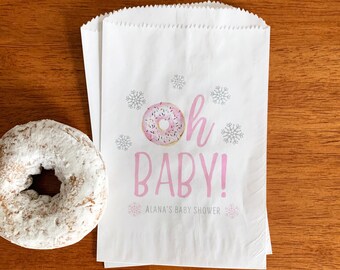 May include: White paper gift bag with a pink and white donut graphic and the text "Oh Baby!" with snowflakes. The text "Alana's Baby Shower" is printed below the graphic.
