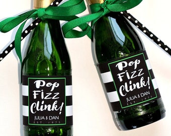May include: Two mini champagne bottles with black and white striped labels that say "Pop Fizz Clink!" with the names Julia & Dan and the year 1975. The bottles are tied with green ribbon and black and white polka dot straws.