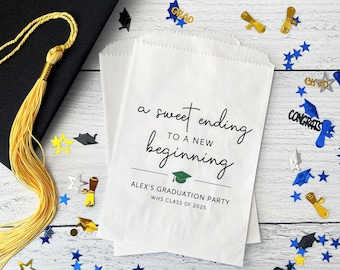 May include: White paper favor bag with black text that reads "a sweet ending to a new beginning" with a green graduation cap icon. The text "ALEX'S GRADUATION PARTY WHS CLASS OF 2025" is below the icon.