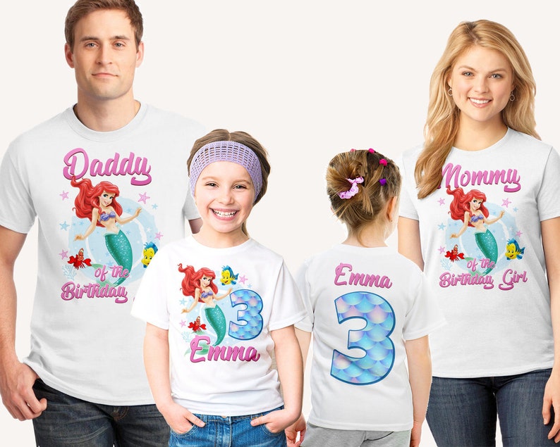 May include: White t-shirts with a mermaid and fish design. The shirts say "Daddy of the Birthday Girl", "Mommy of the Birthday Girl", and "Emma 3".