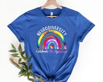 May include: A royal blue t-shirt with a white graphic of a rainbow with the words "Neurodiversity Celebrate The Spectrum" printed on it.