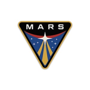 Op de afbeelding: Een zwarte driehoek met het woord "MARS" in witte letters bovenaan. De driehoek heeft een blauw, rood en gouden ontwerp aan de binnenkant met een witte ster en lichtstralen.
