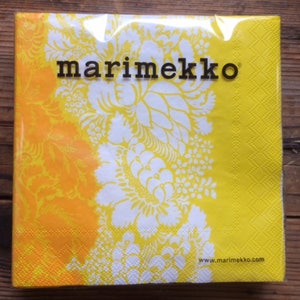 May include: Yellow and white floral patterned paper napkins with the text "marimekko" and "www.marimekko.com" printed on them.