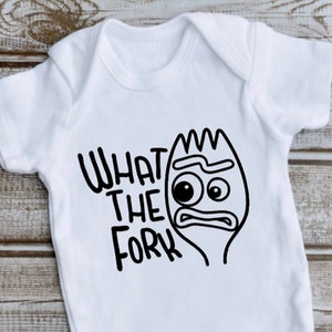May include: White baby onesie with the phrase "WHAT THE FORK" in black, along with a cartoon fork character with an expressive face. The onesie has short sleeves and snap closures.