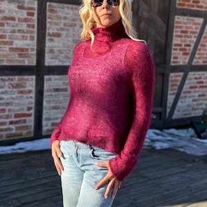 May include: A set of three ceramic mugs with a speckled, matte finish. The mugs are in shades of cream, light gray, and dark gray. Each mug has a simple, minimalist design and a rounded handle.