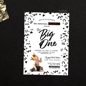 May include: A white and black geometric patterned invitation for a first birthday party. The invitation says "Join us to celebrate the notorious Levi turning The Big One" and includes the date and time of the party. The invitation also features a photo of a baby wearing a gold crown.