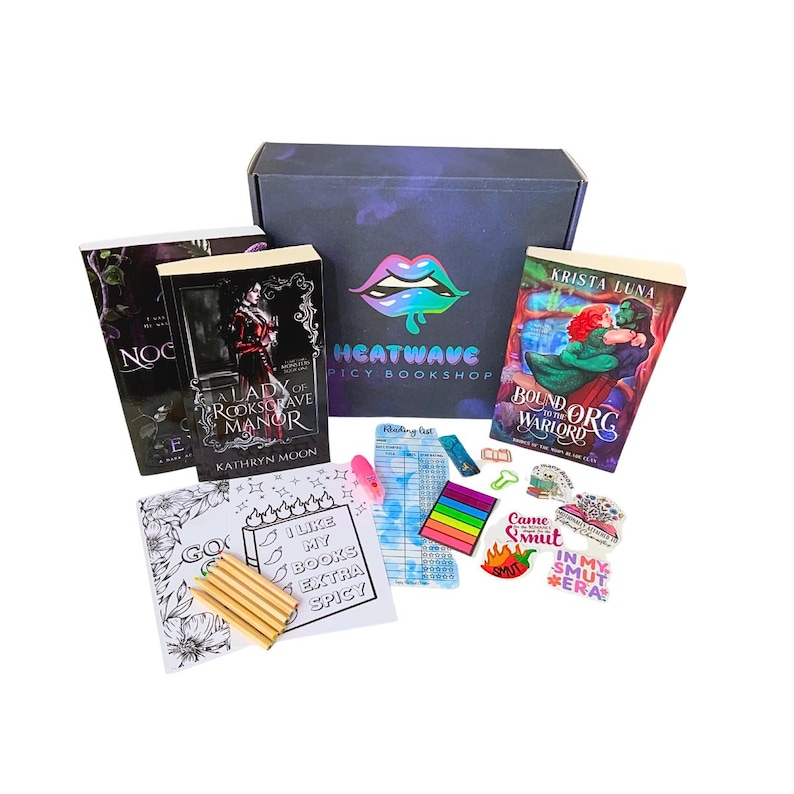 May include: A book box set with several books, stickers, and coloring supplies. The box has a holographic logo that says "Heatwave Spicy Bookshop". The books include "A Lady of Rooksgrave Manor" and "Bound to the Orc Warlord".