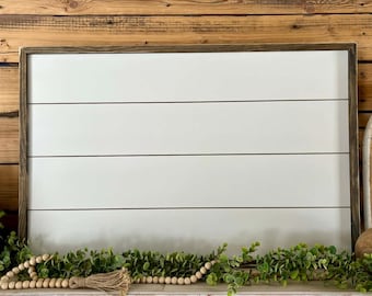 May include: A rectangular sign with a smooth white surface featuring three horizontal black lines, framed in dark brown wood. The sign is positioned horizontally and has a clean, flat appearance suitable for custom lettering or display.