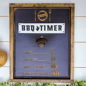 May include: A wooden sign with a black background and white lettering that reads "BBQ TIMER". The sign has a bottle opener and a chart with different levels of doneness for meat, including "Rare", "Medium", "Well Done", and "Order Pizza".