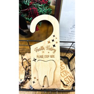 May include: Wooden tooth fairy door hanger with a tooth shape and the text "Tooth Fairy Please Stop Here".