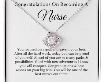 May include: A silver necklace with a pendant featuring a central clear crystal surrounded by a swirling design. The card reads "Congratulations On Becoming A Nurse" with an inspirational message below. A thoughtful gift.