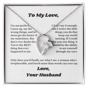 May include: A silver-toned heart-shaped pendant necklace with a central clear gemstone, presented in a white box. The box contains a heartfelt message, including the words "To My Love" and "Love, Your Husband."