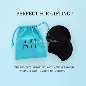 May include: A pair of black velvet ear warmers with a turquoise blue velvet pouch. The pouch has the text "HANDMADE Applement House APPLEMINT HOUSE A&Pi; EST 2014" printed on it.