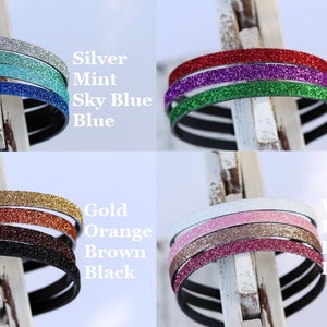 May include: A set of 10 glitter headbands in various colors, including silver, mint, sky blue, blue, red, lavender, green, gold, orange, brown, white, pink, pale pink, and hot pink.