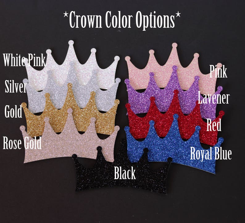 May include: A selection of glitter crowns in various colors, including white, pink, silver, gold, rose gold, lavender, red, royal blue, and black. The crowns are arranged in a row, with the colors listed below each crown. The text "*Crown Color Options*" is at the top of the image.