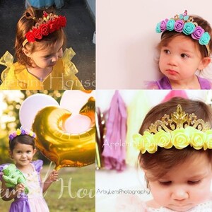 May include: Three young girls wearing flower crowns. The crowns are made of plastic and have a variety of colors, including red, yellow, blue, and purple. The crowns are decorated with glitter and have a small plastic tiara on top.