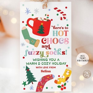May include: A holiday-themed gift tag with a festive design. The tag features a red mug of hot chocolate, socks, and the text "Here's to Hot Chocs and Fuzzy Socks!" with a holiday greeting. The tag is editable.