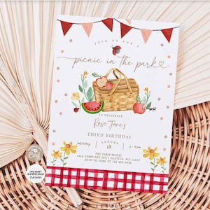 May include: Editable picnic in the park birthday party invitation template with a red and white gingham background. The invitation features a watercolour illustration of a picnic basket with fruit, a watermelon, and a ladybug. The text reads "Join us for a picnic in the park to celebrate Rose Jane's third birthday, August 18, 2-4pm, The Farm Picnic, 1456 February Ave | Seattle, WA 12569, RSVP to Febe at 125 456 9896".